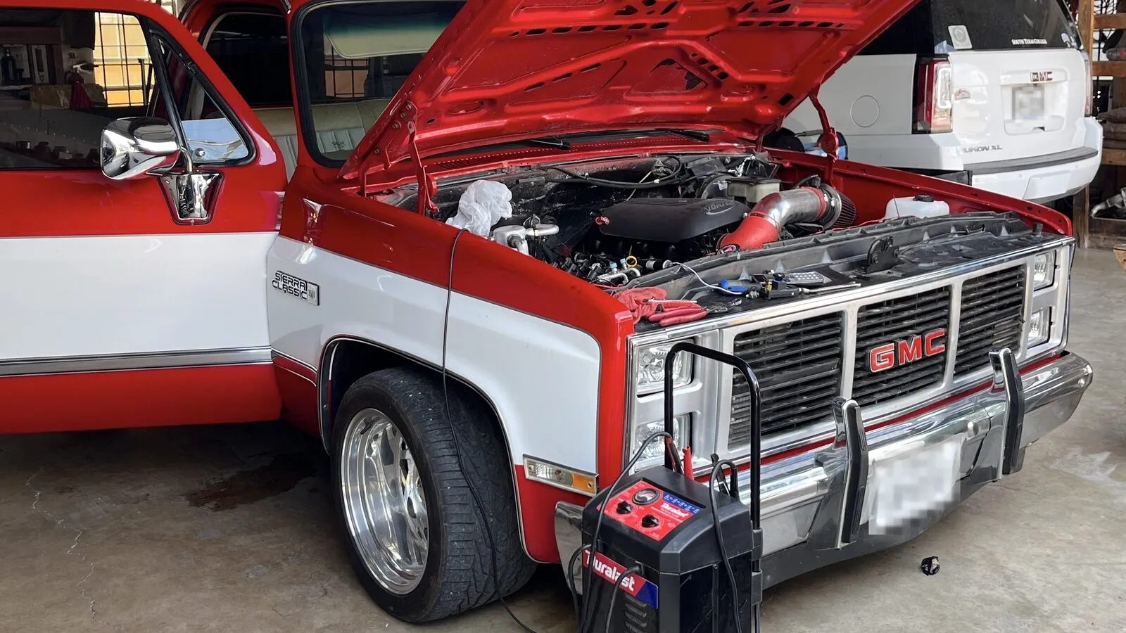 Battery and charging system testing equipment connected to a truck at Rio Auto Electric