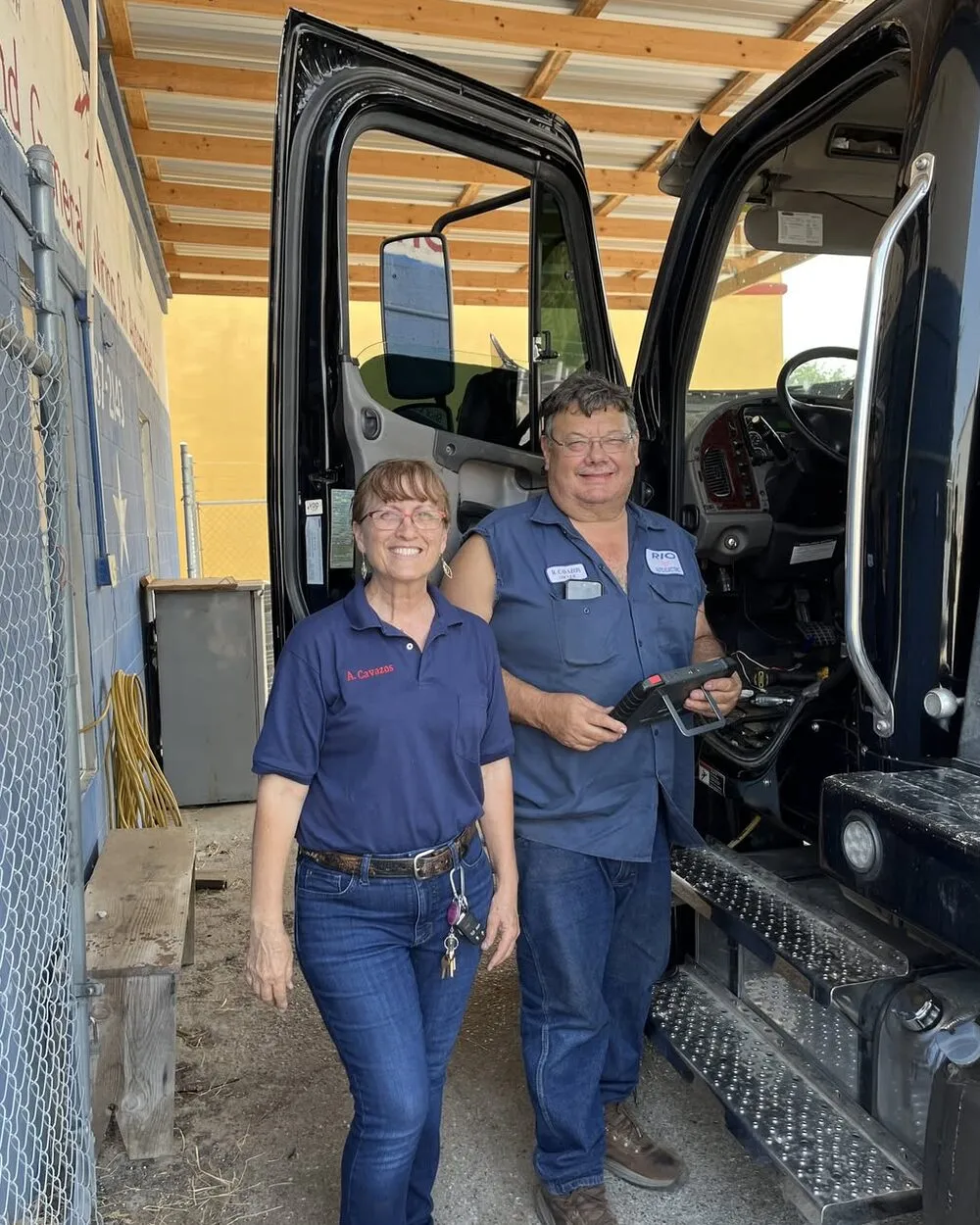 Rey and Ana Cavazos, owners of Rio Auto Electric, standing beside a heavy duty truck at their Rio Grande City shop