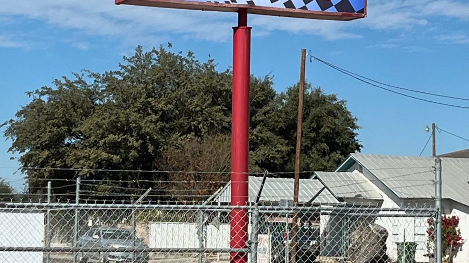 The Rio Auto Electric sign on its pole outside the shop in Rio Grande City, Texas