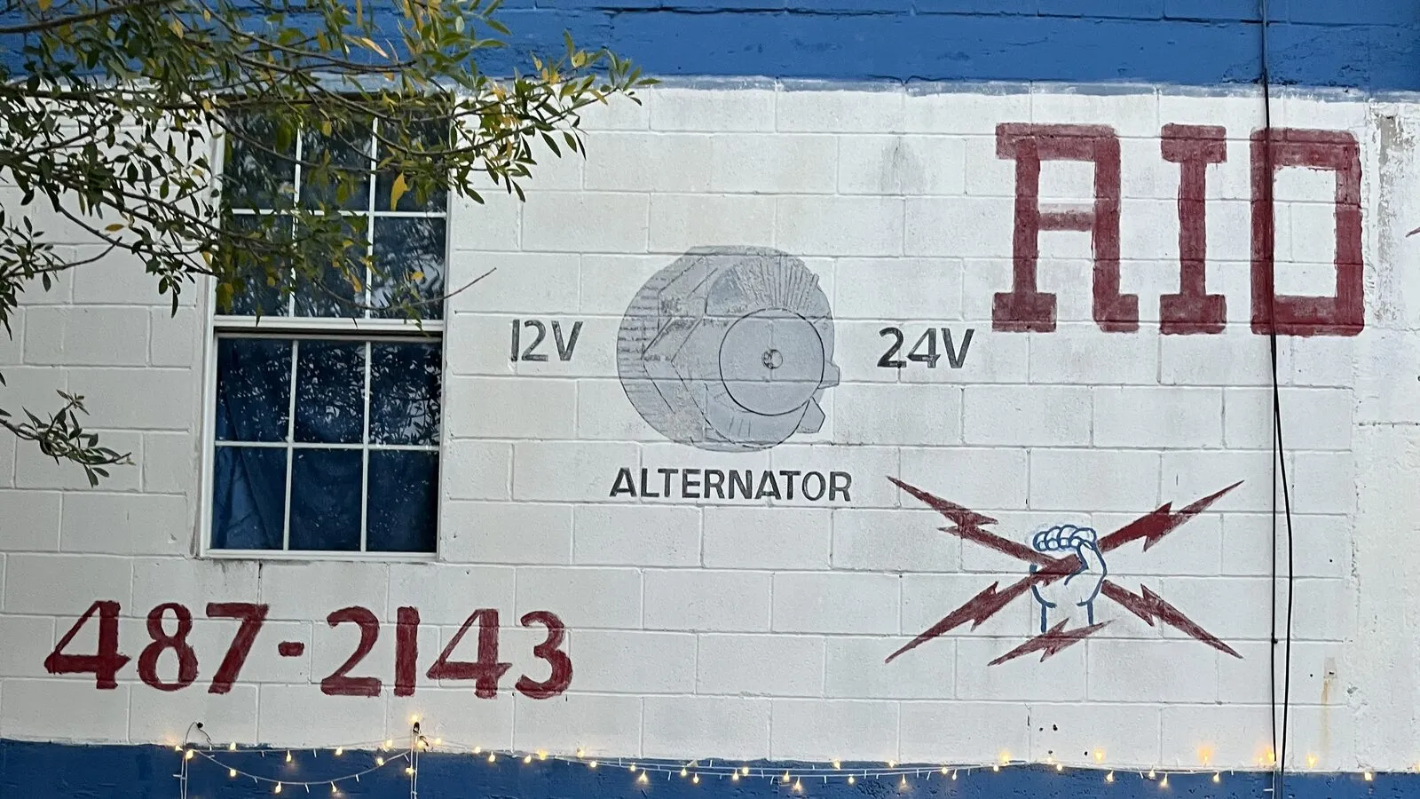 The hand painted 12V and 24V alternator sign on the side of the Rio Auto Electric building